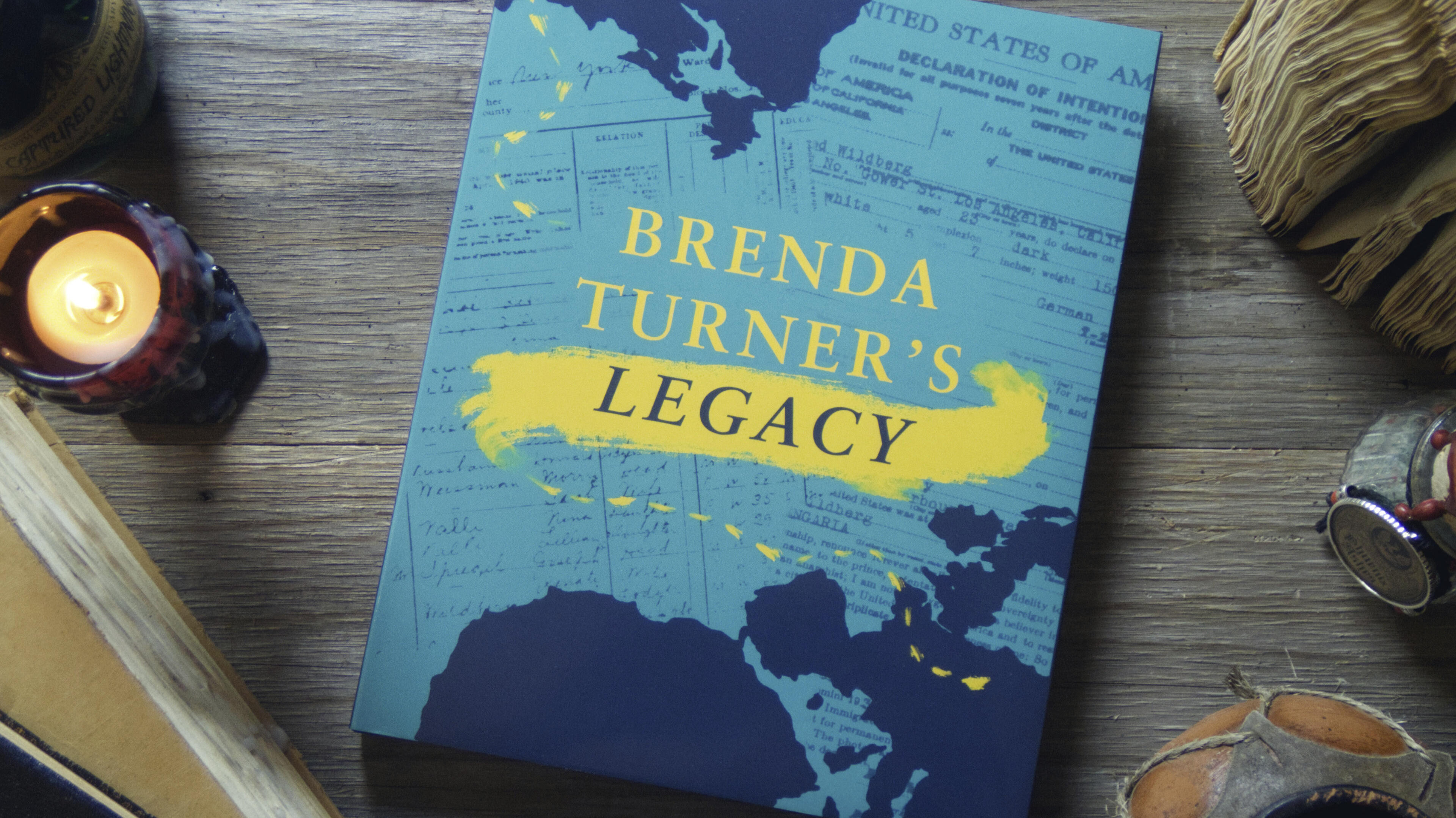 This time, a large hardcover is shown. Its book jacket shows a background of scanned travel documents from the subject's life, with a dotted brushstroke showing her path. It reads: Brenda Turner's Legacy